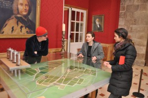 Laetitia of Chateau Haut-Brion shows Chris and Natasha a model of the vineyard